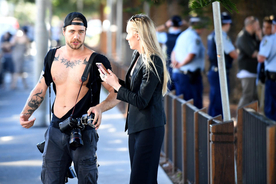 NewsCorp photographer Dylan Robinson (left) and reporter Eliza Barr are seen after a confrontation with a member of the public following a press conference with Senator Fraser Anning at Dunningham Park at Cronulla in Sydney, Friday, April 25, 2019. (AAP Image/Joel Carrett) NO ARCHIVING