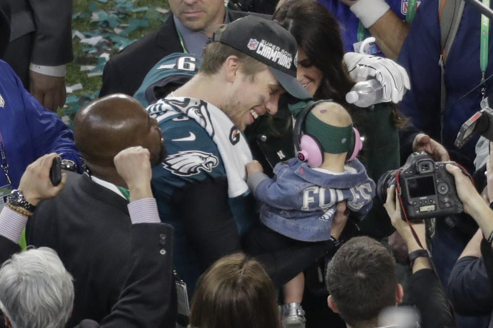 Philadelphia Eagles quarterback Nick Foles celebrates with his daughter, Lily, and wife, Tori, after Super Bowl 52 on Sunday. The Eagles beat the New England Patriots, 41-33. (AP)