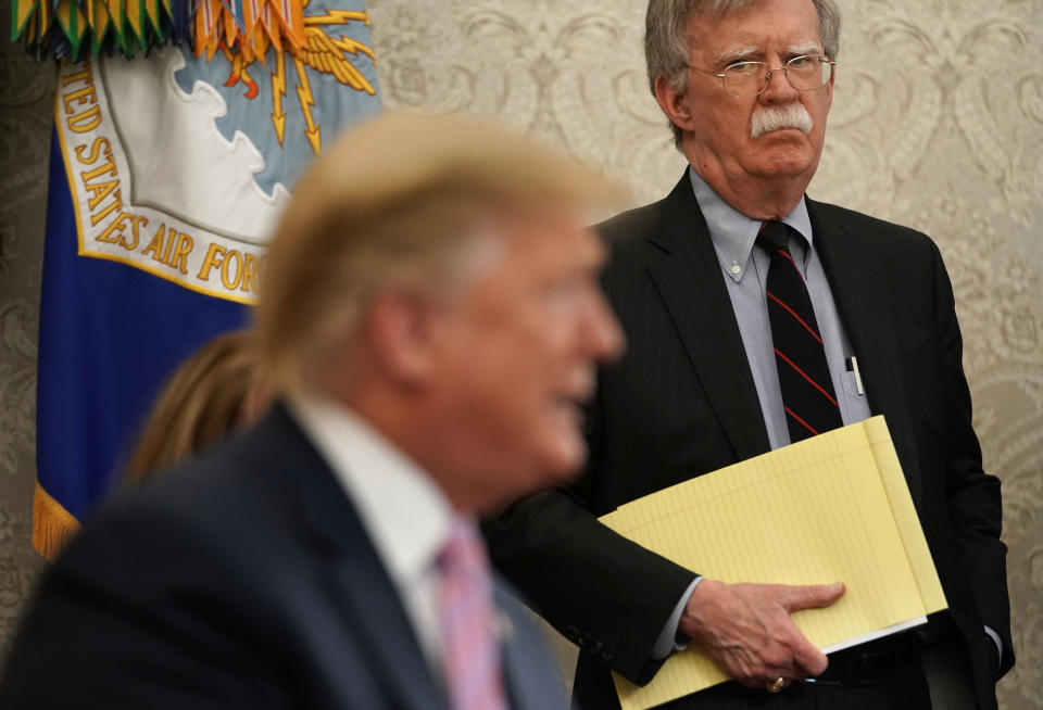 National security adviser John Bolton listens to President Trump in the Oval Office of the White House on April 9, 2019. / Credit: Getty Images