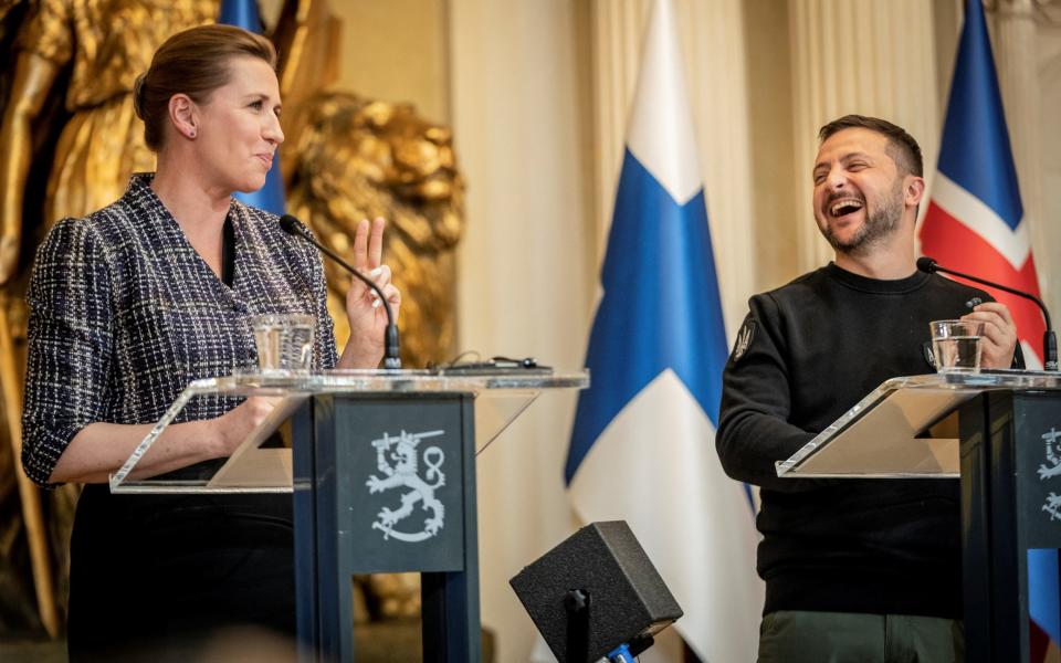 Danish Prime Minister Mette Frederiksen and Ukrainian President Volodymyr Zelenskiy laughs at a press conference with the Nordic heads of state during the Nordic-Ukrainian Summit, at the Presidential Palace in Helsinki, Finland - RITZAU SCANPIX/via REUTERS