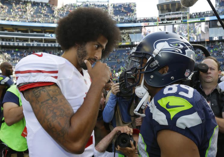 Colin Kaepernick and Doug Baldwin talk after a game in Seattle (AP)
