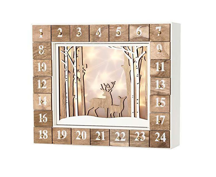 <p><strong>BRUBAKER</strong></p><p>amazon.com</p><p><strong>$46.99</strong></p><p>Watch your family's faces <em>and</em> this calendar light up each day, thanks to built-in LED lighting. You can also re-use this one year after year, making it part of your family's tradition.</p><p><strong>RELATED: </strong><a href="https://www.goodhousekeeping.com/holidays/gift-ideas/g29343476/reusable-advent-calendars" rel="nofollow noopener" target="_blank" data-ylk="slk:Best Reusable Advent Calendars;elm:context_link;itc:0;sec:content-canvas" class="link ">Best Reusable Advent Calendars</a></p>