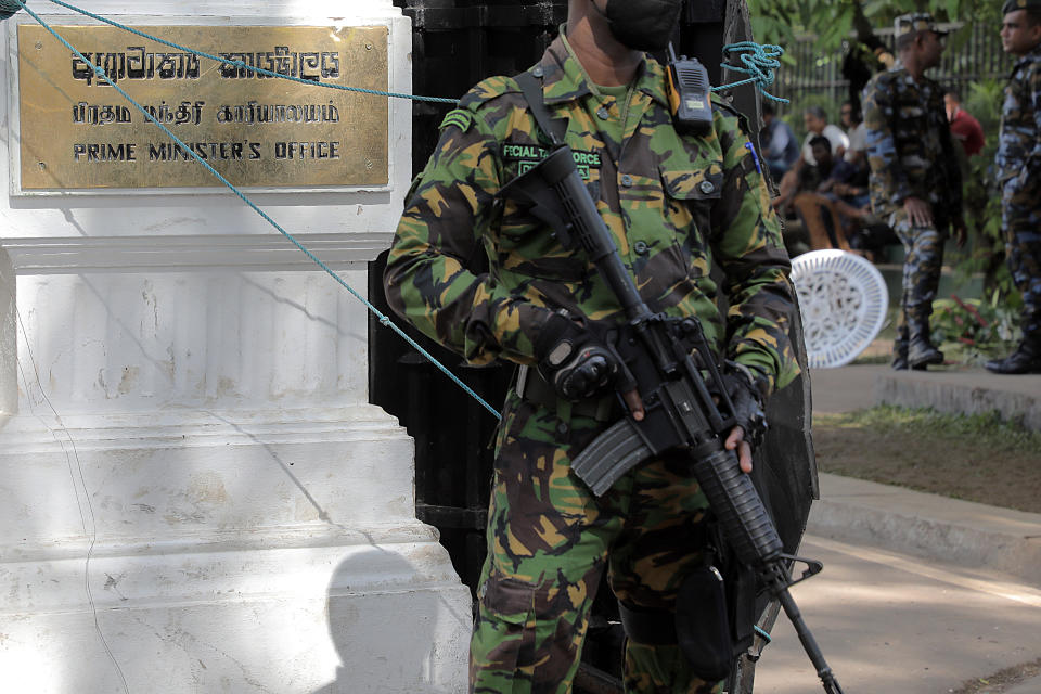 COLOMBO, SRI LANKA - JULY 14. An armed Sri Lanka Police Special Task Force personnel stands guard at the gate of the colonial building that is the Prime Ministerâs office at Flower Road in Colombo, Sri Lanka, 14 July 2022., Sri Lanka, 14 July 2022. Protestors forcibly entered the Prime Ministerâs office yesterday, similar to what they did earlier to the Presidentâs House and the Prime Ministerâs official residence Temple Trees. This was followed by hundreds of inquisitive people entering and vandalizing the places. With President Gotabaya Rajapaksa leaving the island Prime Minister Ranil Wickremesinghe took over as Acting President and declared a state of emergency and imposed a curfew yesterday (13 July), which was lifted at 5.00 this morning and again re-imposed at 12 noon today. Following requests from several quarters the protestors agree to hand over the premises to the authorities. (Photo by M.A.Pushpa Kumara/Anadolu Agency via Getty Images)