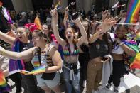 Spectators cheer along the Pride parade route, Saturday, June 10, 2023, in Boston. The biggest Pride parade in New England returned on Saturday after a three-year hiatus, with a fresh focus on social justice and inclusion rather than corporate backing. (AP Photo/Michael Dwyer)