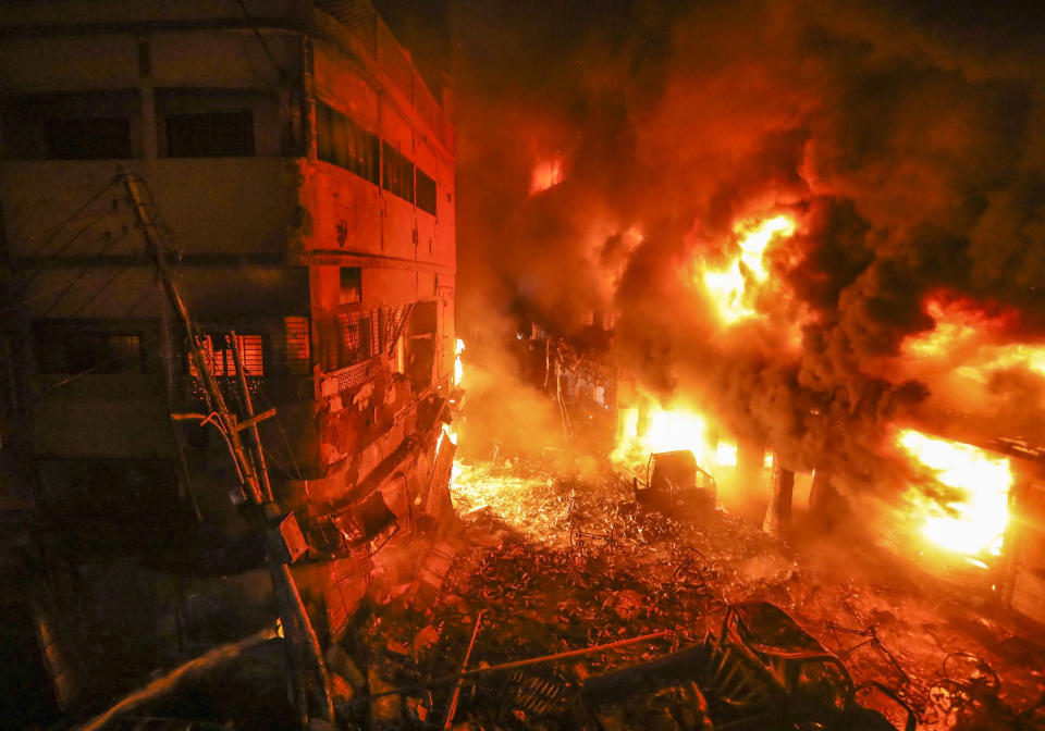 Flames rise from a fire in a densely packed shopping area in Dhaka, Bangladesh, Thursday, Feb. 21, 2019. A devastating fire raced through at least five buildings in an old part of Bangladesh's capital and killed scores of people. (AP Photo/Zabed Hasnain Chowdhury)