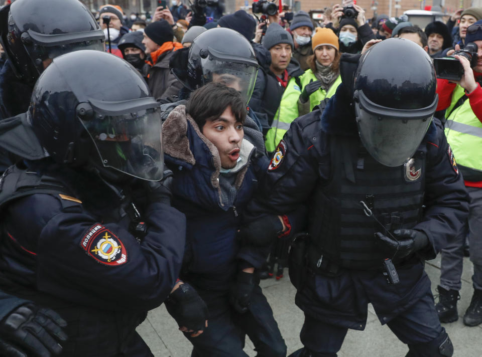 FILE - In this Jan. 23, 2021, file photo, police detain a man protesting the jailing of opposition leader Alexei Navalny in Moscow, Russia. Rattled by the nationwide demonstrations in support of the Kremlin foe, Russian authorities are moving rapidly to block any new ones – from piling legal pressure on his allies to launching a campaign to discredit the demonstrations. (AP Photo/Pavel Golovkin, File)