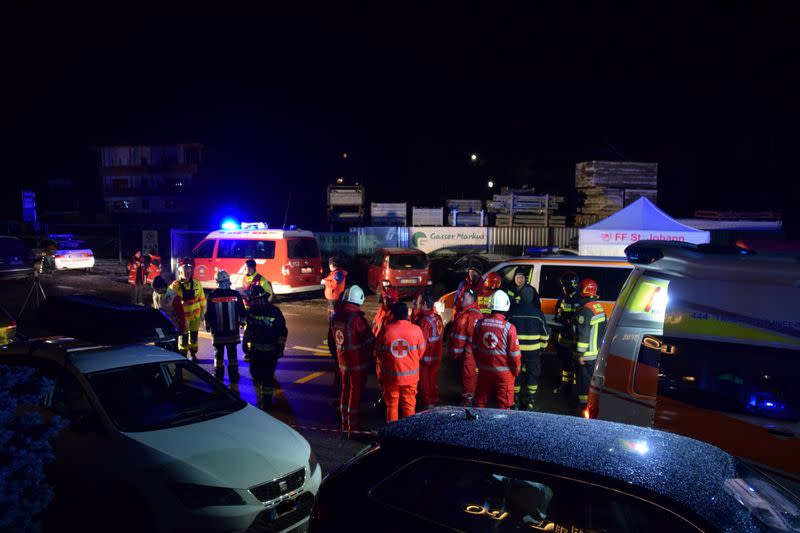 Ambulance and fire crews work at the scene where a male driver of a car hit a group of German tourists, killing six in Lutago
