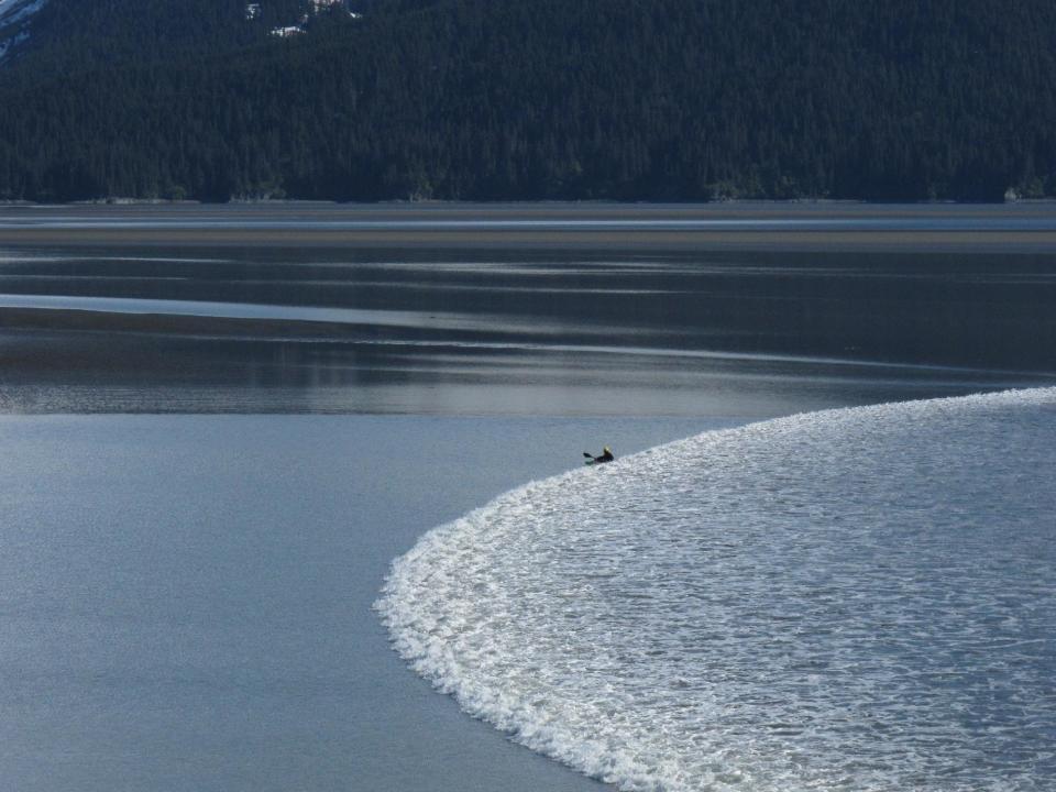 A kayaker catches the leading edge of the biggest bore tide of the summer as it roared into Turnagain Arm south of Anchorage, Alaska, on Tuesday, June 5, 2012. Bore tides can happen all over the world, but Anchorage's Turnagain Arm and Knik Arms are the only places in the United States where they occur regularly, according to Michael Lawson a meteorologist with the National Weather Service in Anchorage. (AP Photo/Ron Barta)