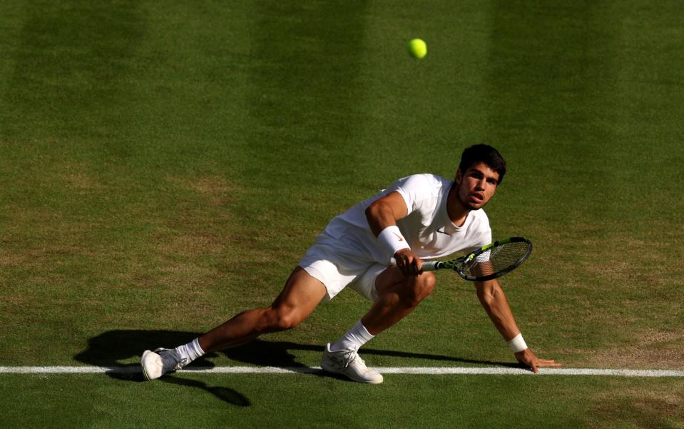 Carlos Alcaraz of Spain plays a forehand against Holger Rune of Denmark in the Men&#39;s Singles Quarter Final match during day ten of The Championships Wimbledon 2023 at All England Lawn Tennis and Croquet Club on July 12, 2023 in London, England