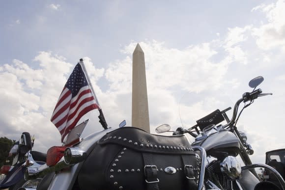 Motorcycle flying American flag at Washington Monument