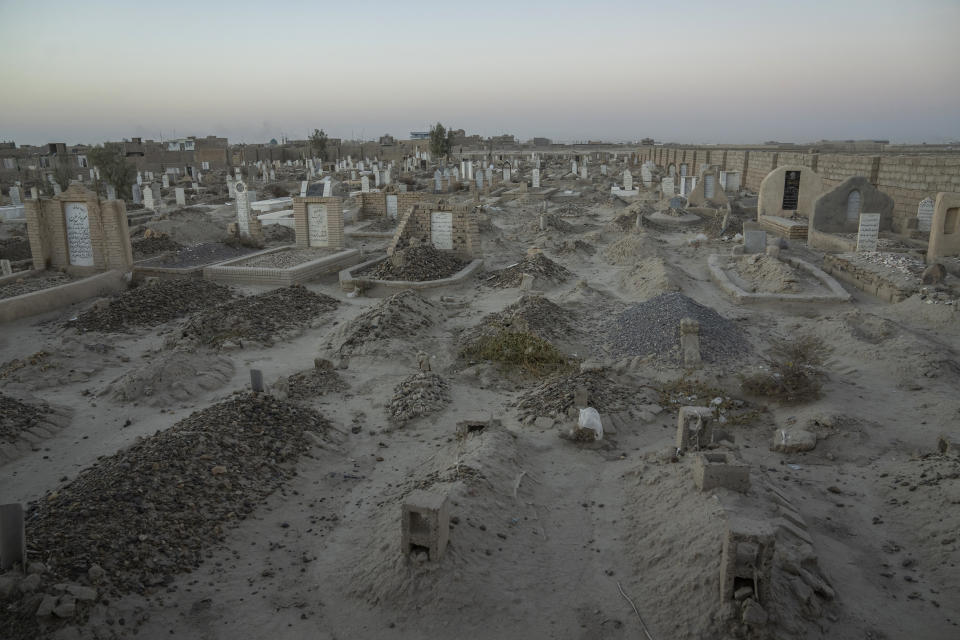 An Afghan Shiite cemetery, where a large number of Shiite migrants who were killed while trying to cross the border are buried, lies on the outskirts of Zaranj city, Afghanistan, Monday, Dec. 25, 2023. According to locals, when Shiites cross the border into Pakistan, they are attacked by the Jundollah group, taken hostage and released after paying a lot of money, or killed. To avoid the Jundollah, Shiite immigrants try to cross over the border wall, although it is much more difficult and usually unsuccessful. (AP Photo/Ebrahim Noroozi)