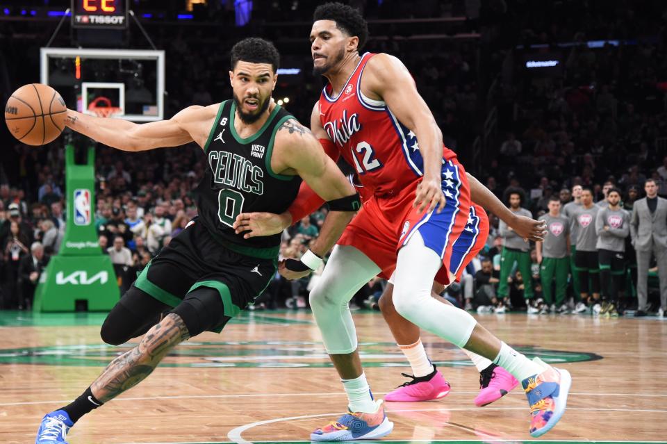 Celtics forward Jayson Tatum drives around 76ers forward Tobias Harris in the second half of Monday's first game in their conference semifinal on Monday. Tatum finished with 39 points but Boston lost, 119-115.