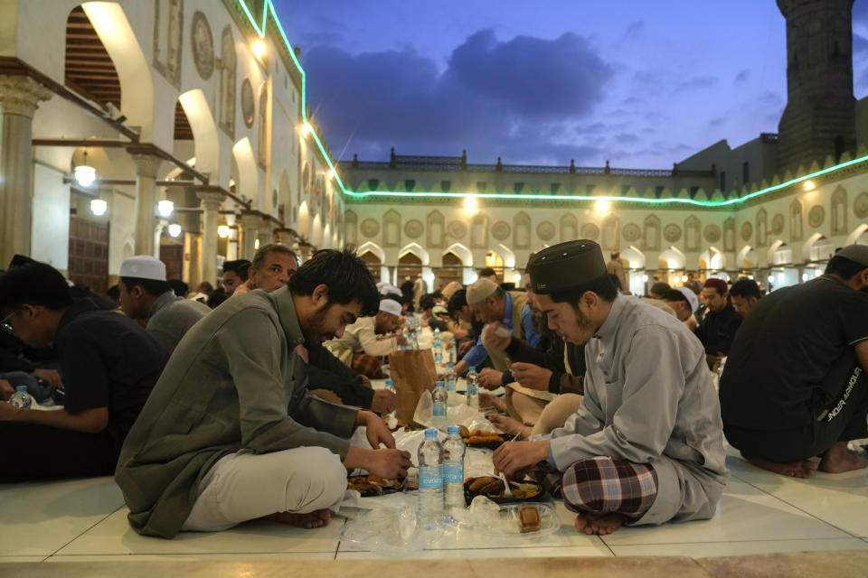 FILE - Worshippers break their fast during the Muslim holy month of Ramadan, at a free meal distribution point in Al-Azhar mosque, the Sunni Muslim world's premier Islamic institution, in Cairo, Egypt, Saturday, March 25, 2023. (AP Photo/Amr Nabil, File)