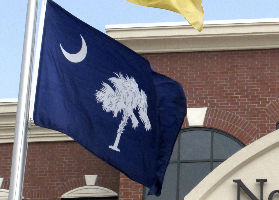 The South Carolina flag flies outside city hall in North Charleston, S.C., Aug. 12, 2011. The state will hold runoff elections on Tuesday, June 25, 2024, to decide a handful of races where no candidate received a vote majority in the primary held just two weeks earlier. (AP Photo/Bruce Smith, File)