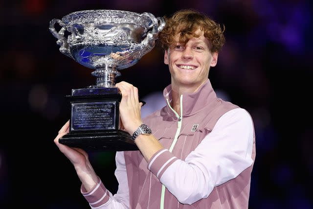 <p>Cameron Spencer/Getty</p> Jannik Sinner with the Norman Brookes Challenge Cup during the official presentation after their Men's Singles Final match against Daniil Medvedev during the 2024 Australian Open on January 28, 2024 in Melbourne, Australia.