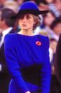 <p>In a blue-and-black color-block Bruce Oldfield hat. </p>
