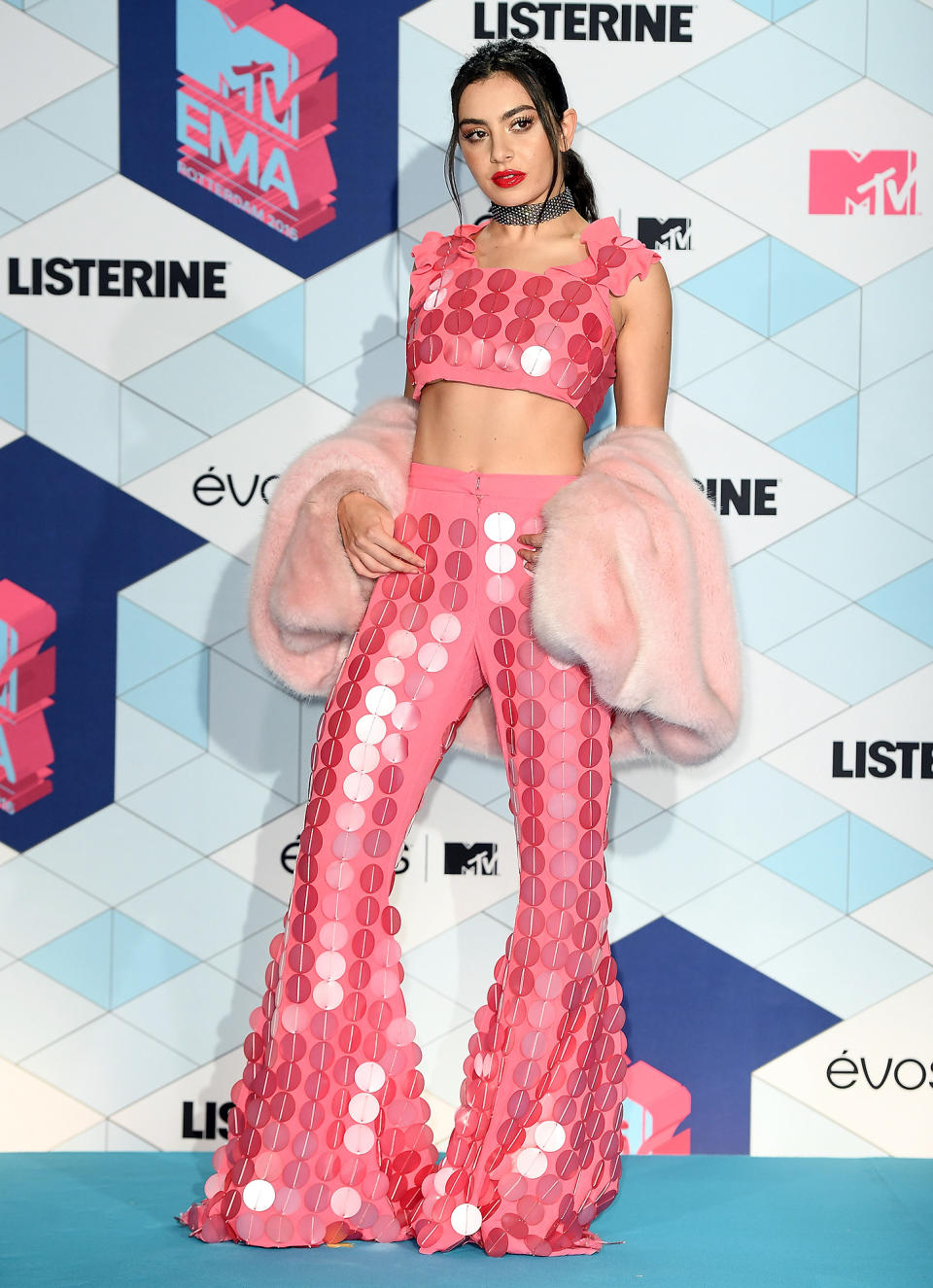 <p>Bell-bottom pants are having a serious moment amongst celebrities, but the pop star gave hers an extra dash of sparkle thanks to a whole lot of jumbo pink pailettes</p>