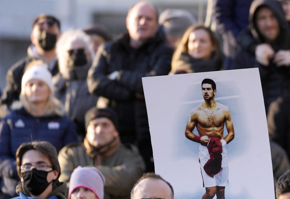 Supporters of Serbia's Novak Djokovic protest in Belgrade, Serbia, Friday, Jan. 7, 2022. Several hundred people gathered outside Serbian parliament in a show of support for Serbian tennis player Novak Djokovic as he battles the Australian legal system in an attempt to be allowed to stay in the country and compete in the Australian Open later this month. (AP Photo/Darko Vojinovic)