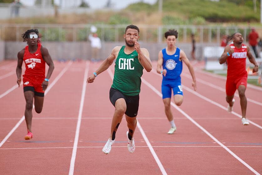 Granada Hills sprinter Jordan Coleman, center, wins his heat in the 100-meter dash.