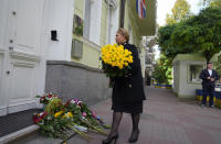 Former Ukrainian Prime Minister Yulia Tymoshenko lays flowers in remembrance of Queen Elizabeth II, at the British Embassy, in Kyiv, Ukraine, Friday, Sept. 9, 2022. (AP Photo/Efrem Lukatsky)