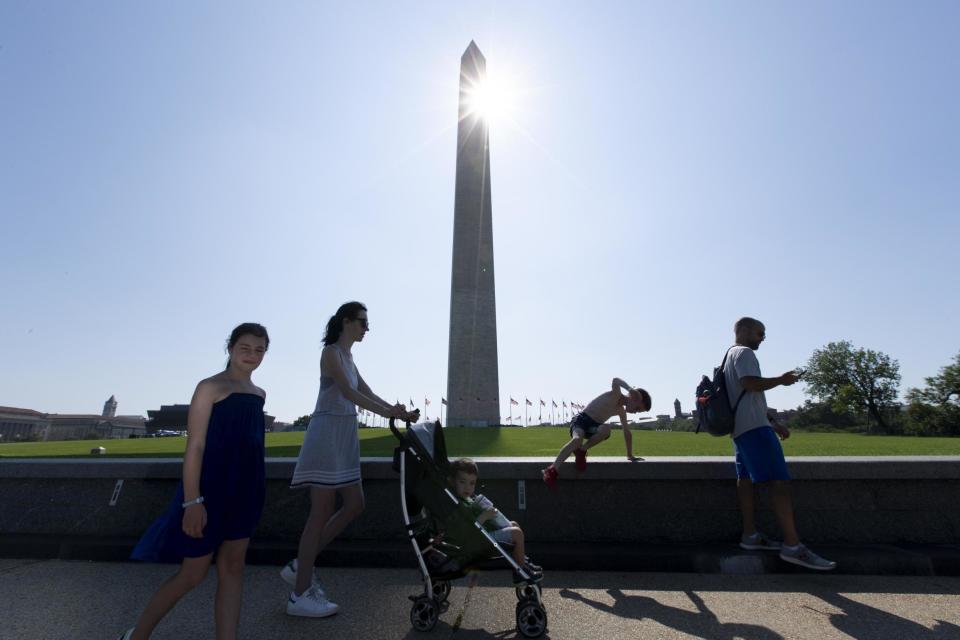 People walk near the Washington Monument (EPA)