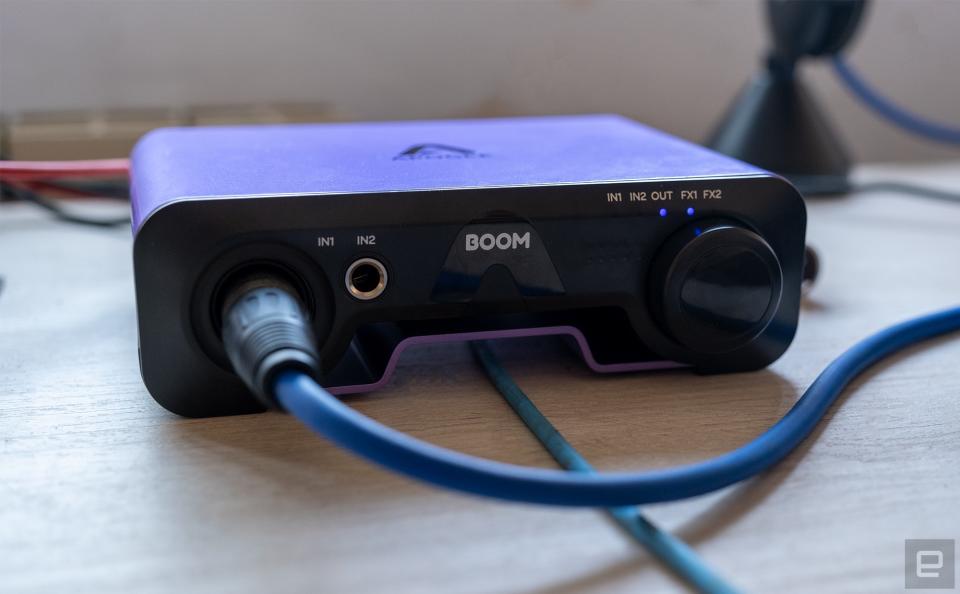 The new Apogee Boom audio interface is pictured with the headphone cable running through the gap in the base.