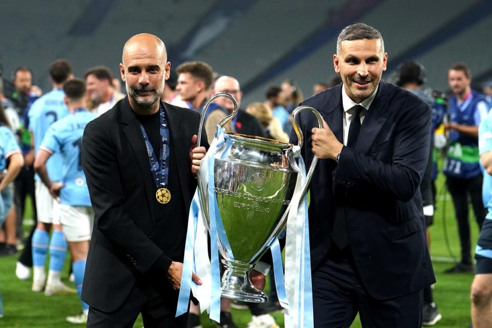 Pep Guardiola holds the Champions League trophy with Man City chairman Khaldoon Khalifa Al Mubarak (Martin Rickett/PA) (PA Wire)