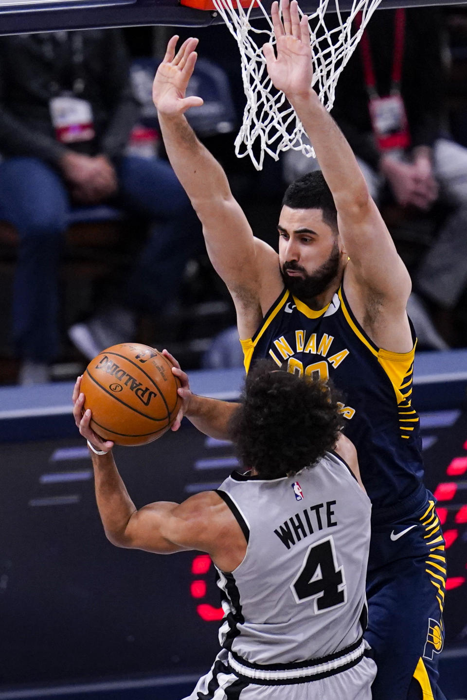 Indiana Pacers center Goga Bitadze (88) stops the shot of San Antonio Spurs guard Derrick White (4) during the first half of an NBA basketball game in Indianapolis, Monday, April 19, 2021. (AP Photo/Michael Conroy)