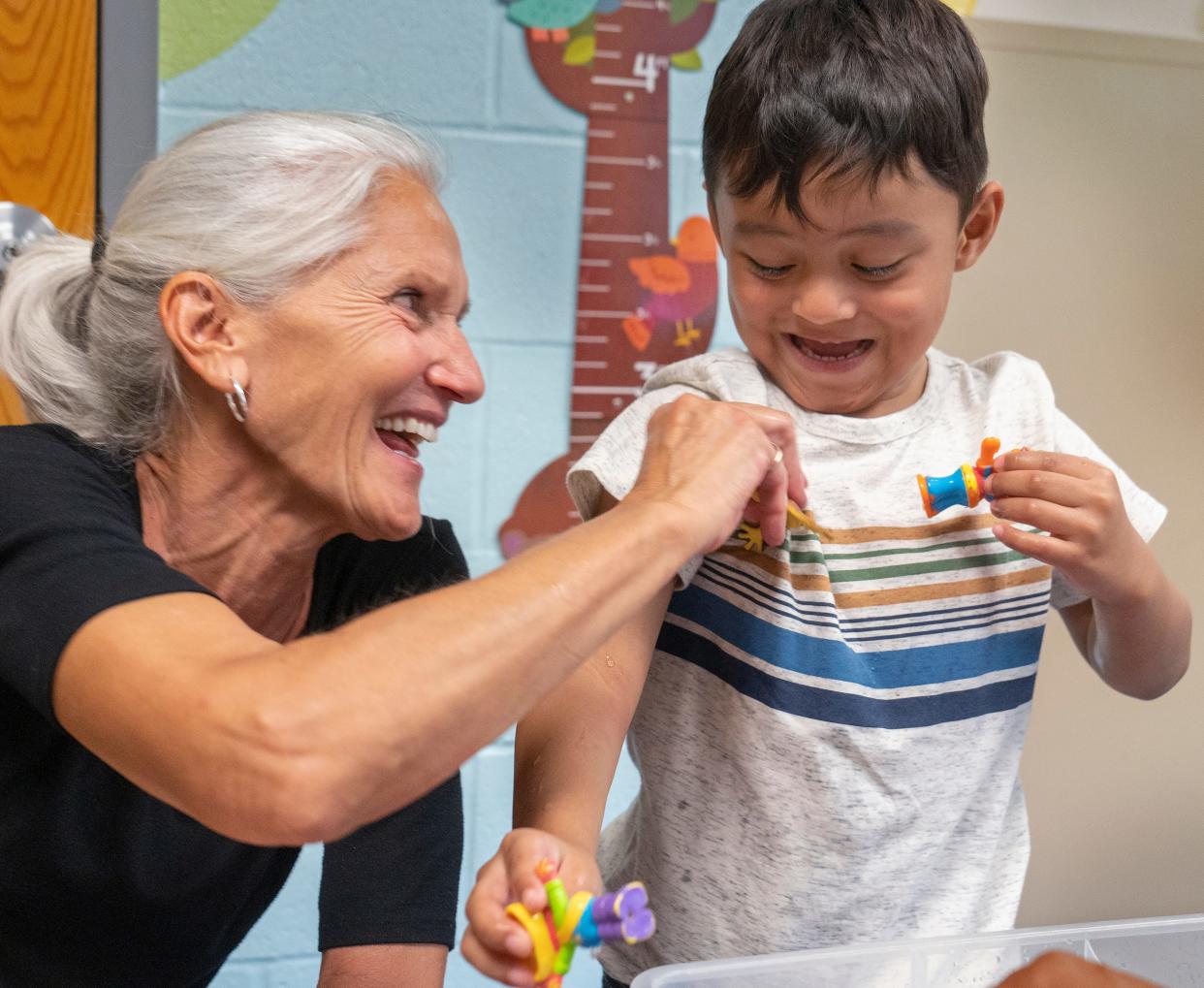 Teacher Amy Engelhardt, left, plays and laughs with Javier Govea in the pre-K classroom Monday, July 31, 2023 at Carl Wilde School IPS #79.