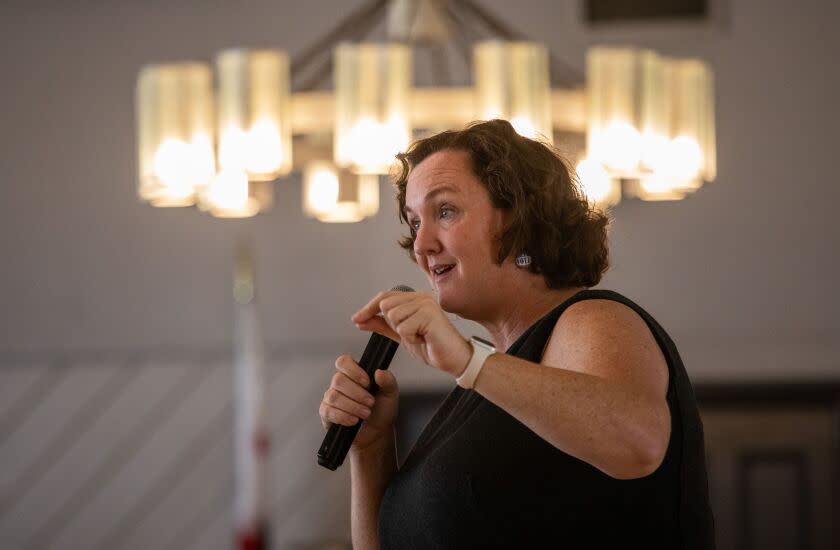 Rep. Katie Porter addresses a crowd in Huntington Beach on Oct. 17