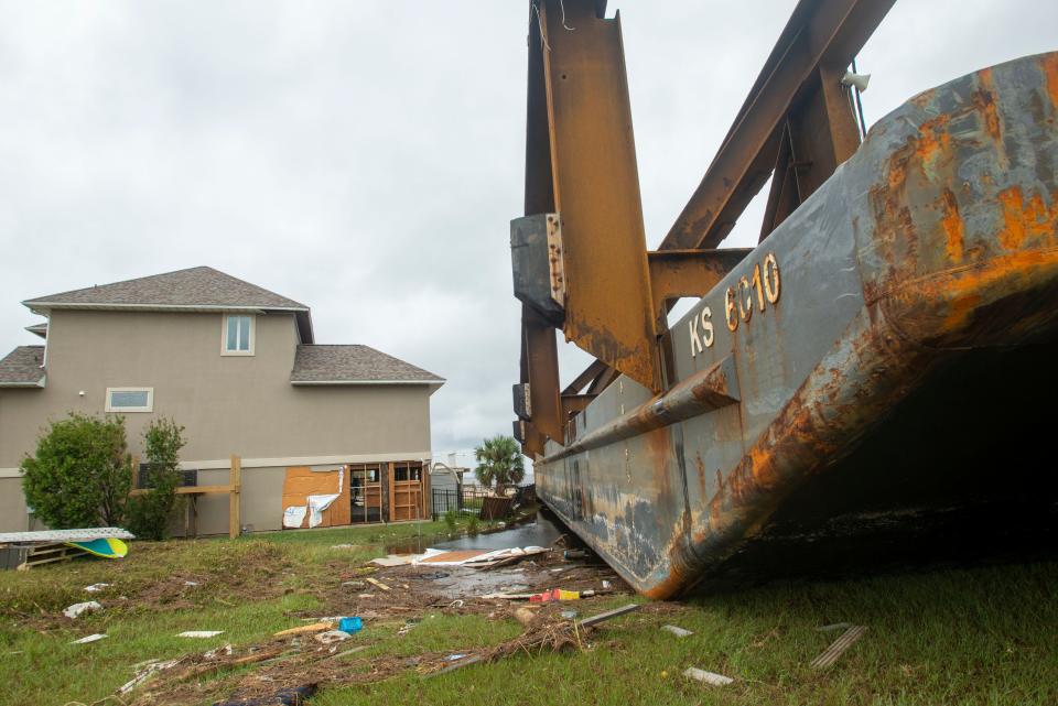 One of several Skanska USA barges that broke loose during Hurricane Sally rests near the home of Joanne Nisewonger in Pensacola, Fla., on Sept. 20, 2020.