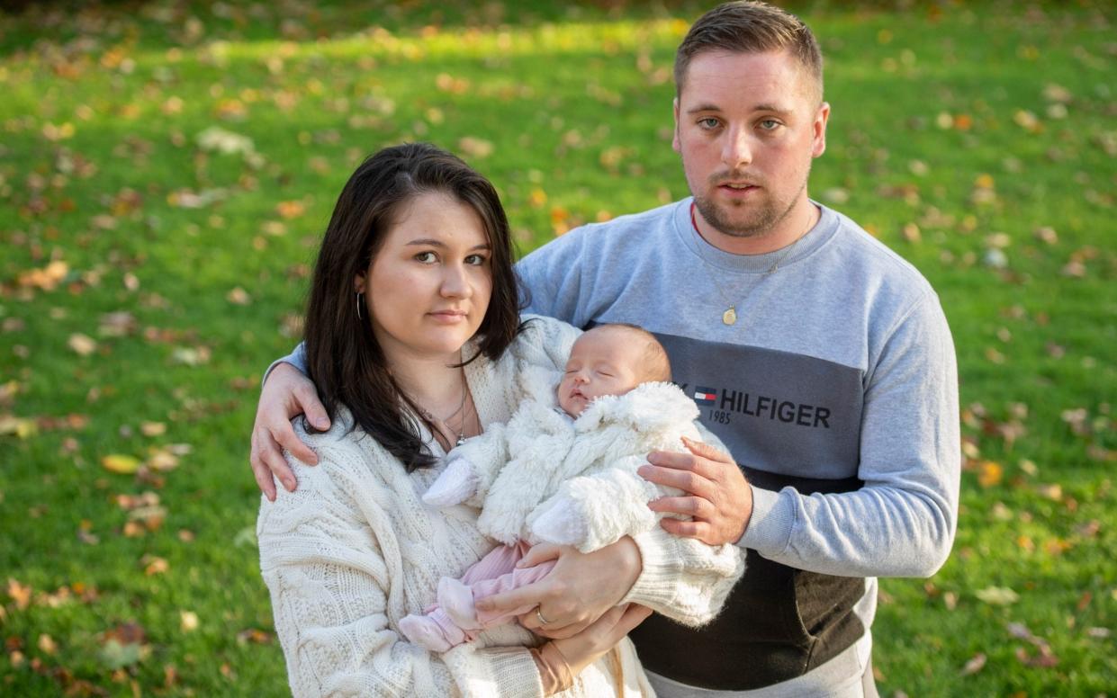 Elena Sala poses in the park with her newly born daughter Lola and husband Dave - Paul Grover for the Telegraph