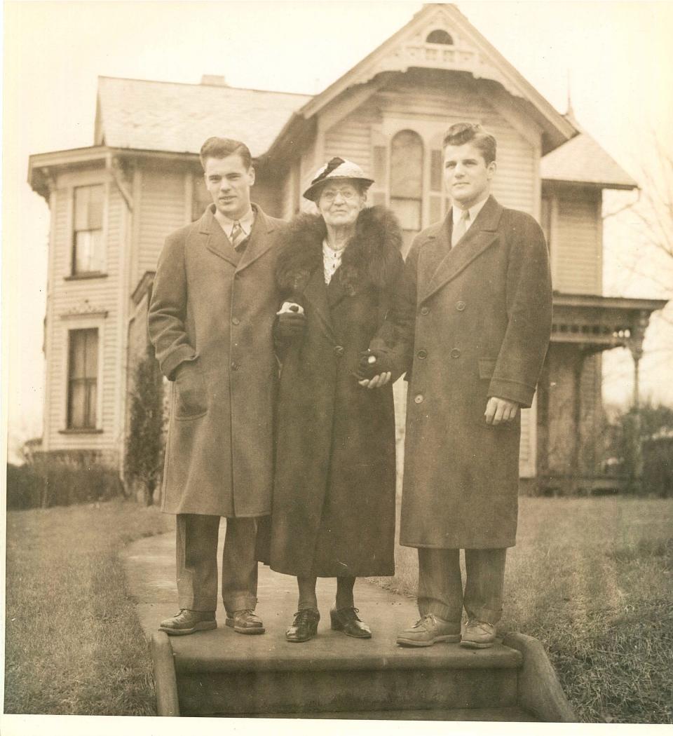 (Left to right) Karl Compton, Otelia Compton and Arthur Compton stand in front of their family home.