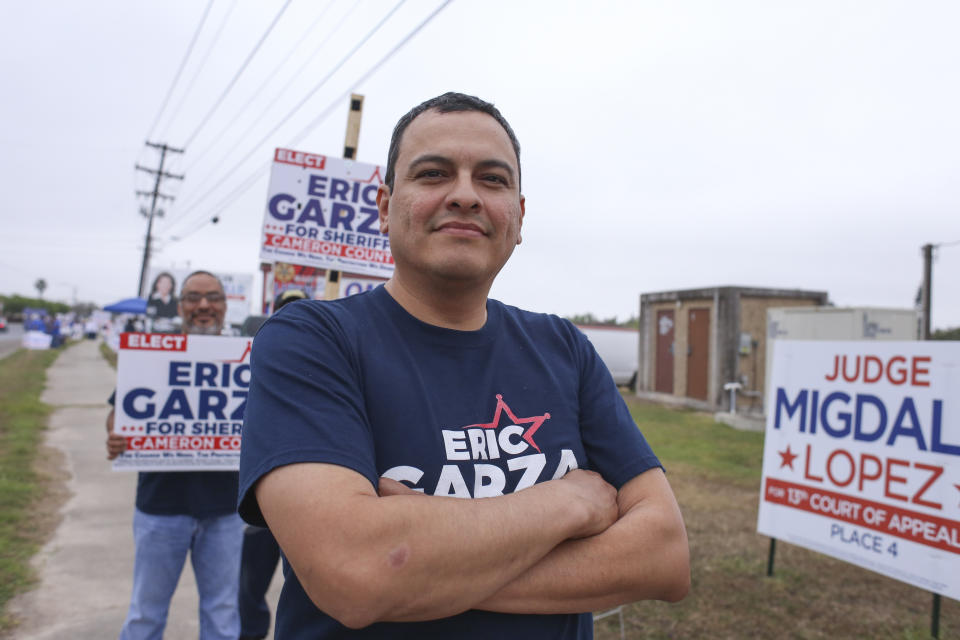 Eric Garza stands with his supporters Tuesday, March 3, 2020, during his campaign for Cameron County Sheriff outside the polling location at Burns Elementary School in Brownsville, Texas. (Denise Cathey/The Brownsville Herald via AP)