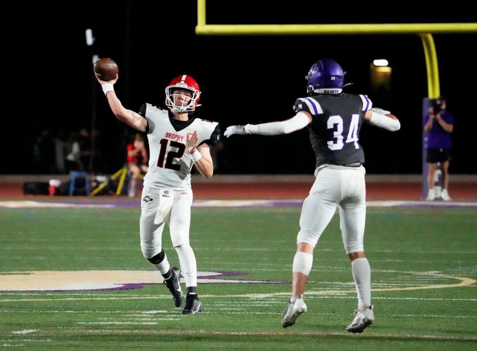 Brophy Prep Broncos quarterback Charlie McGinnis (12) throws a pass against Notre Dame Prep Saints defender Brayden Higby (34) during a game played at Notre Dame Prep in Scottsdale on Sept. 22, 2023.