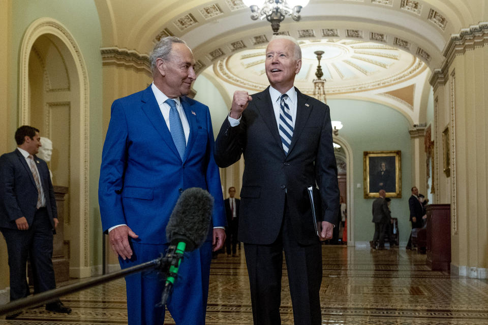 President Joe Biden speaks to members of the media as he stands with Senate Majority Leader Chuck Schumer, D-N.Y., at the Capitol in Washington, Wednesday, July 14, 2021. (AP Photo/Andrew Harnik)