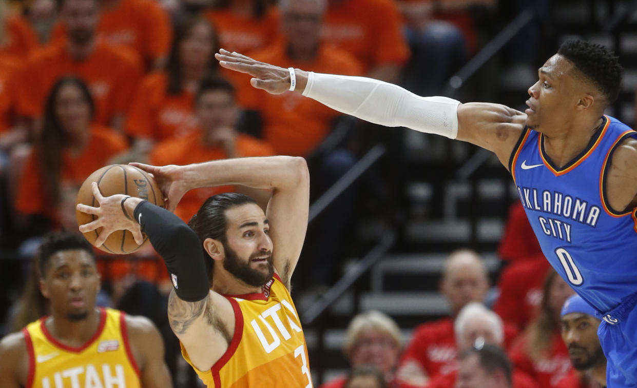 Oklahoma City Thunder guard Russell Westbrook defends as Utah Jazz guard Ricky Rubio passes the ball in the first half during Game 3. (AP Photo/Rick Bowmer)