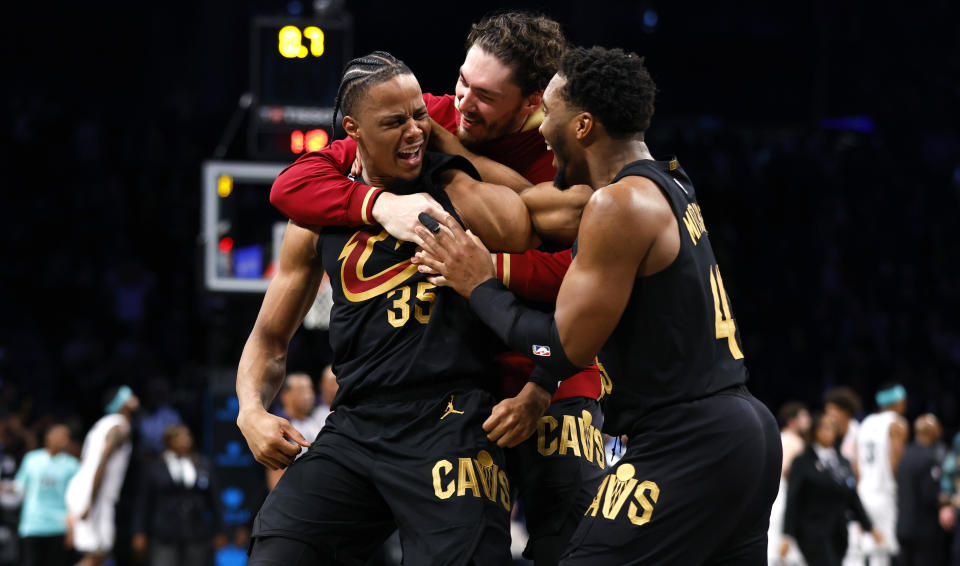 Cleveland Cavaliers forward Isaac Okoro celebrates with teammates Cedi Osman and Donovan Mitchell, right, after making the game winning shot against the Brooklyn Nets during the second half of an NBA basketball game, Thursday, March 23, 2023, in New York. The Cleveland Cavaliers won 115 - 109. (AP Photo/Noah K. Murray)