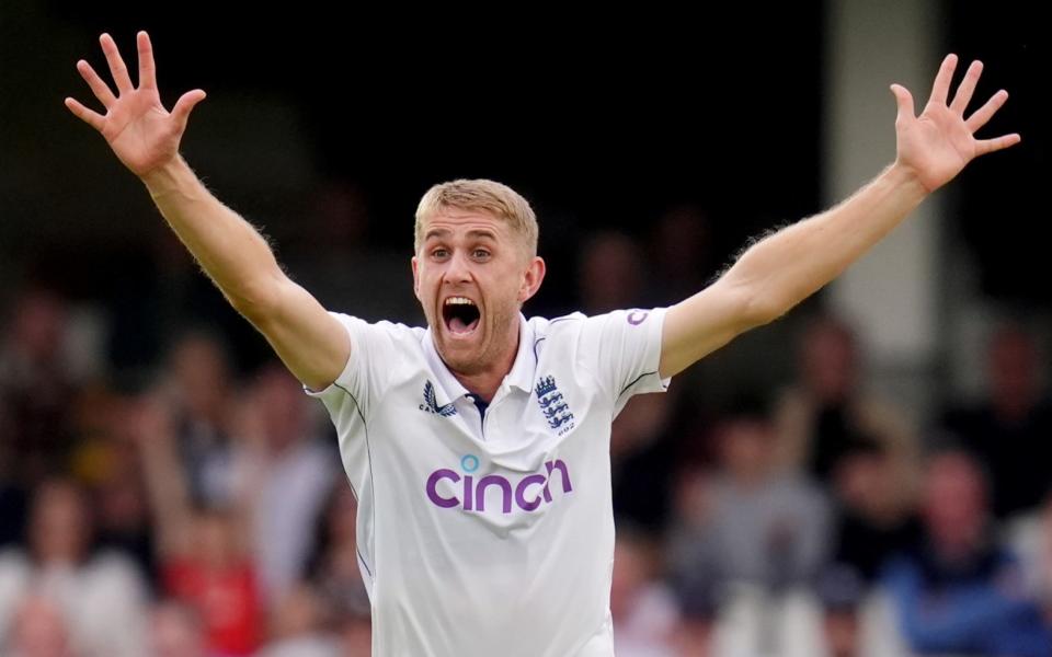 Olly Stone celebrates taking the wicket of Dinesh Chandimal