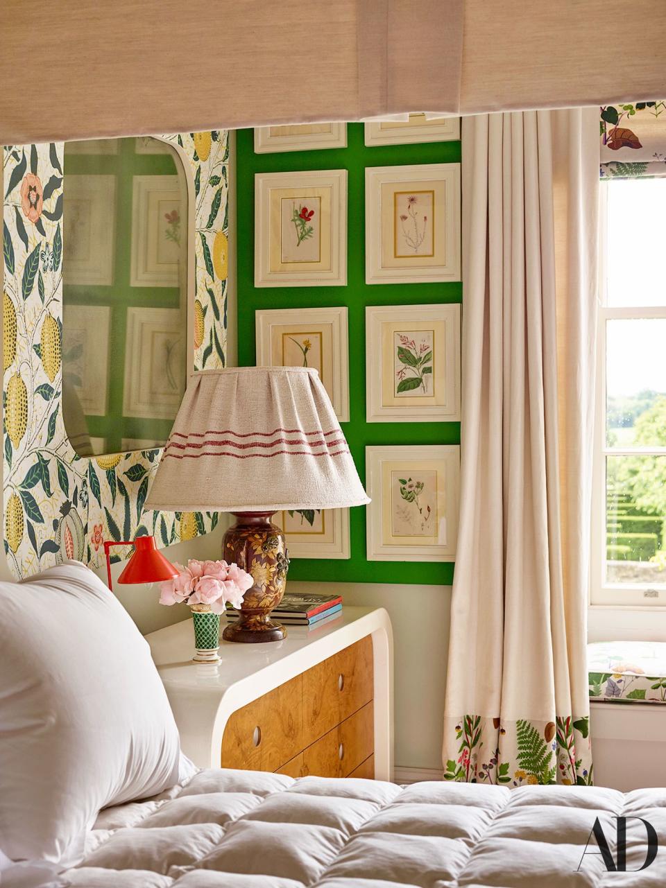 In a guest room, watercolor botanical prints are echoed in Josef Frank floral patterns.