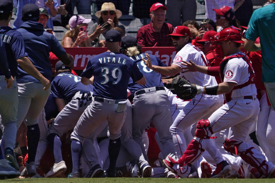 Several members of the Seattle Mariners and the Los Angeles Angels scuffle after Mariners' Jesse Winker was hit by a pitch during the second inning of a baseball game Sunday, June 26, 2022, in Anaheim, Calif. (AP Photo/Mark J. Terrill)