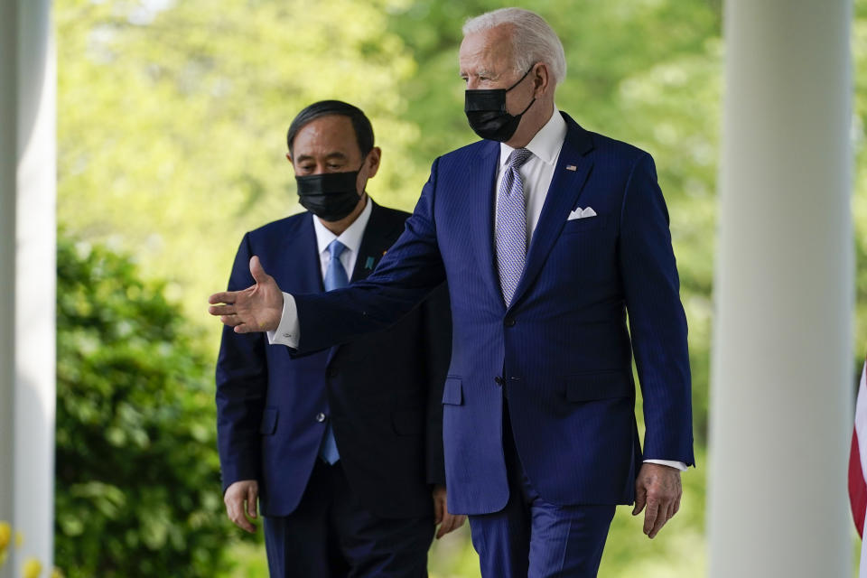 President Joe Biden, accompanied by Japanese Prime Minister Yoshihide Suga, walks from the Oval Office to speak at a news conference in the Rose Garden of the White House, Friday, April 16, 2021, in Washington. (AP Photo/Andrew Harnik)