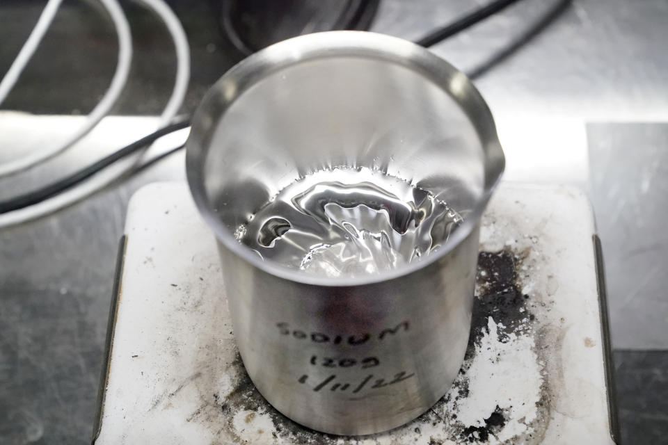 Molten sodium sits in a beaker atop a hot plate as part of a demonstration at TerraPower, a company developing and building small nuclear reactors, Thursday, Jan. 13, 2022, in Everett, Wash. Bill Gates, the man who revolutionized personal computing, is launching an ambitious project to counter climate change: A nationwide reboot of nuclear energy technology. In November, Gates' company TerraPower announced it had chosen Kemmerer, Wy., for a nontraditional, sodium-cooled nuclear reactor that will bring on workers from a local coal-fired power plant scheduled to close soon. The project comes as many U.S. states see nuclear emerging as an answer to fill the gap as a transition away from coal, oil and natural gas to reduce greenhouse gas emissions. (AP Photo/Elaine Thompson)