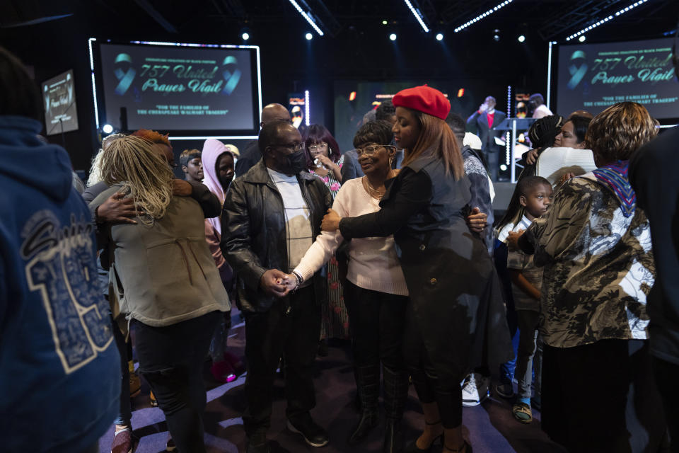 Alonzo and Linda Gamble, center holding hands, parents of Lorenzo Gamble, 43, of Chesapeake, Va., are comforted during a prayer vigil held by the Chesapeake Coalition of Black Pastors at The Mount (Mount Lebanon Baptist Church) in Chesapeake, Va., Sunday, Nov. 27, 2022, for the six people killed at a Walmart in Chesapeake, Va., including Lorenzo Gamble, when a manager opened fire with a handgun before an employee meeting Tuesday night. (AP Photo/Carolyn Kaster)