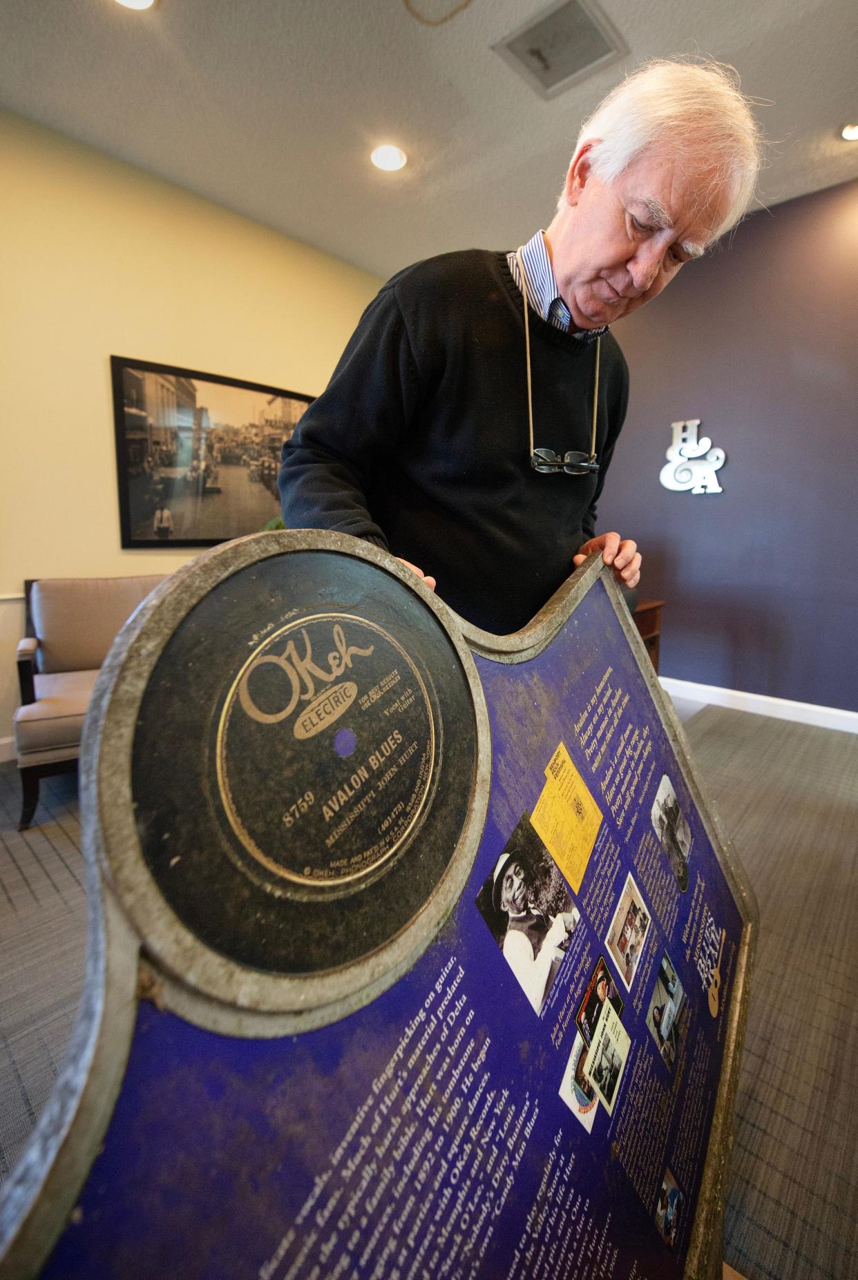 Allan Hammons, manager of the Mississippi Blues Markers project, describes the work needed to restore the John Hurt Blues Marker while at his Greenwood office on Friday. Time and weather have taken a toll. The vinyl on the back of the marker needs to be replaced and the whole marker cleaned.