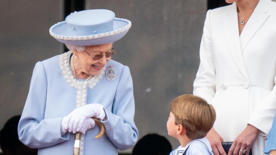 Queen Elizabeth II speaks to Prince Louis on the balcony of Buckingham Palace