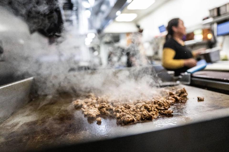 Carne asada is grilled on a gas griddle at La Cosecha Wednesday.