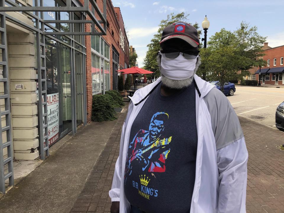 Thomas Richardson stands outside a barber shop in Fayetteville, N.C., Saturday, Sept. 5, 2020. Richardson says he didn't vote for President Donald Trump in 2016 and can't after giving him a chance the past four years because the president is not tough on Russia. (AP Photo/Jeffrey Collins)