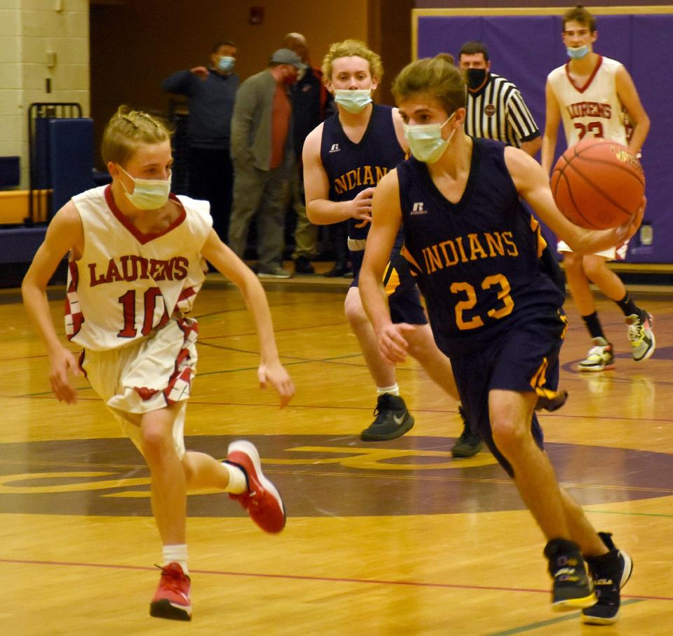 Damon Boss (23) brings the ball up the court for Richfield Springs against Donta Sherwood (10) and the Laurens Leopards during the Richfield Springs Indians Tip-off Tournament consolation game Saturday.