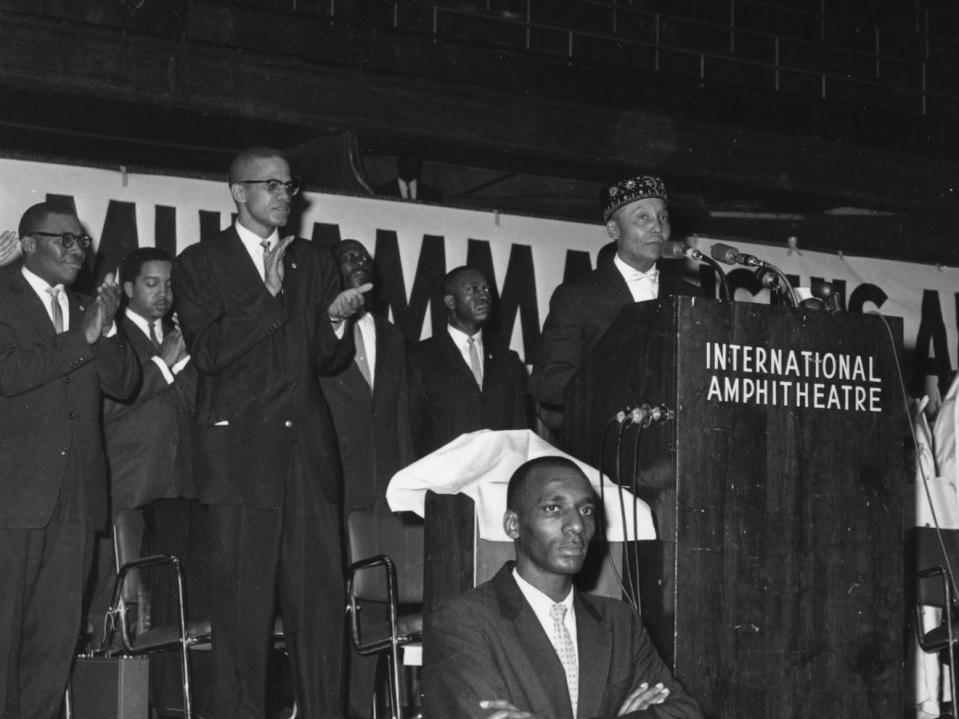 Elijah Muhammad, founder and head of the Nation of Islam, speaks at a lecturn in Chicago, Ill. on Feb. 26, 1961.